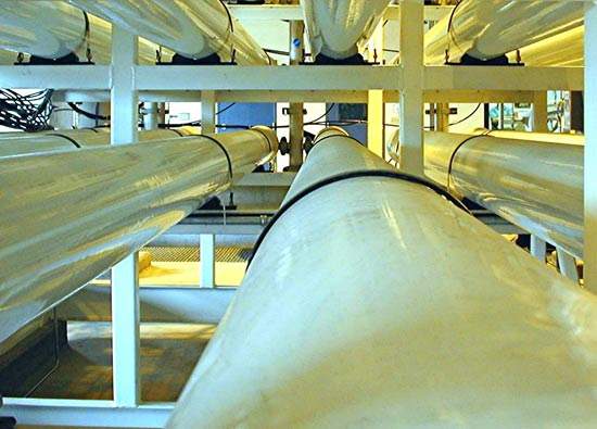The plant uses spiral-wound, thin-film composite membrane elements, housed in cylindrical pressure vessels to desalinate brackish water. The effluent stream passes through an energy-recovery turbine before being discharged to the sea via deep well injection.